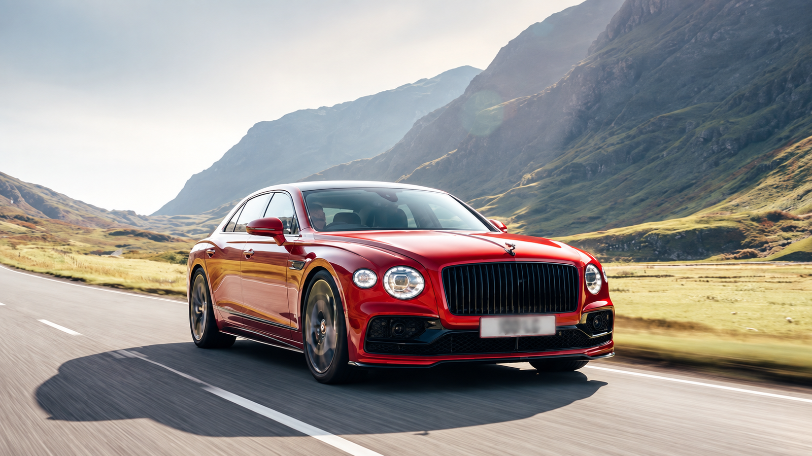 Red Luxury Sedan Through Mountain Valley